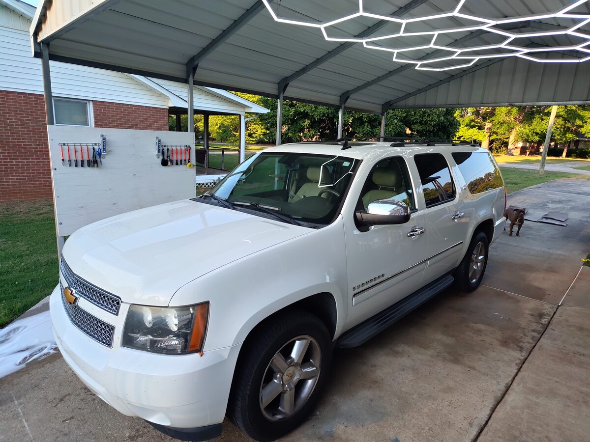 Chevy Suburban LTZ detailed and gleaming under the shop lights at Oak Street Detail